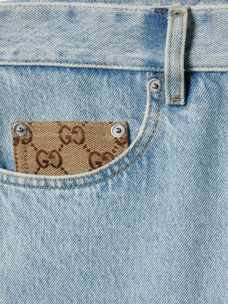 PANTALONE IN DENIM DÉLAVÉ CON INSERTO GG