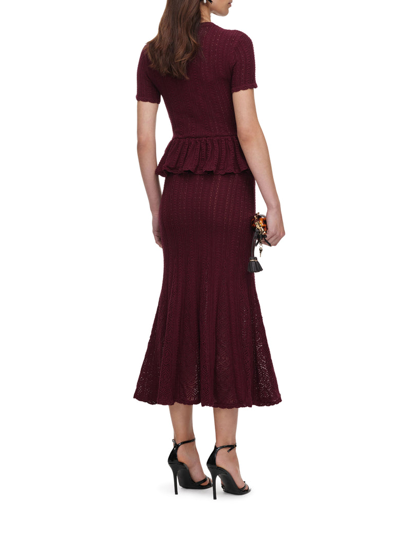 ABITO LUNGO IN MAGLIA TRAFORATA CON PEPLUM E BOTTONI GIOIELLO