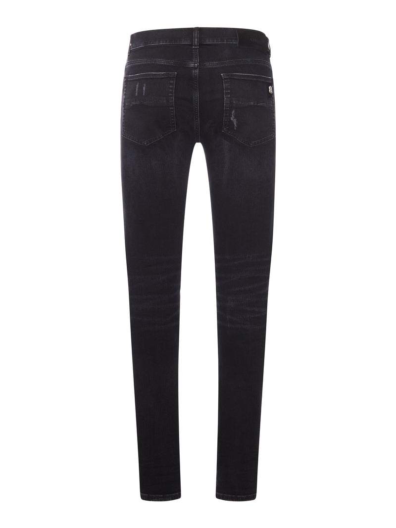 JEANS SKINNY CON BORCHIE E DETTAGLI DESTROY