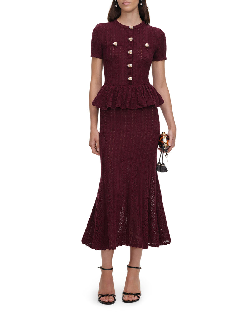 ABITO LUNGO IN MAGLIA TRAFORATA CON PEPLUM E BOTTONI GIOIELLO