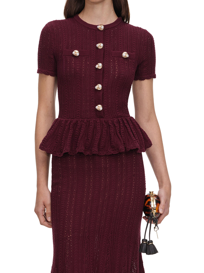 ABITO LUNGO IN MAGLIA TRAFORATA CON PEPLUM E BOTTONI GIOIELLO